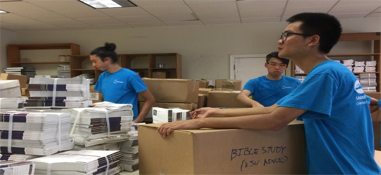 Logos Hope volunteers unpack Love Packages container shipped to Barbados for the churches of Dominica donated by Eagles Nest Ministries